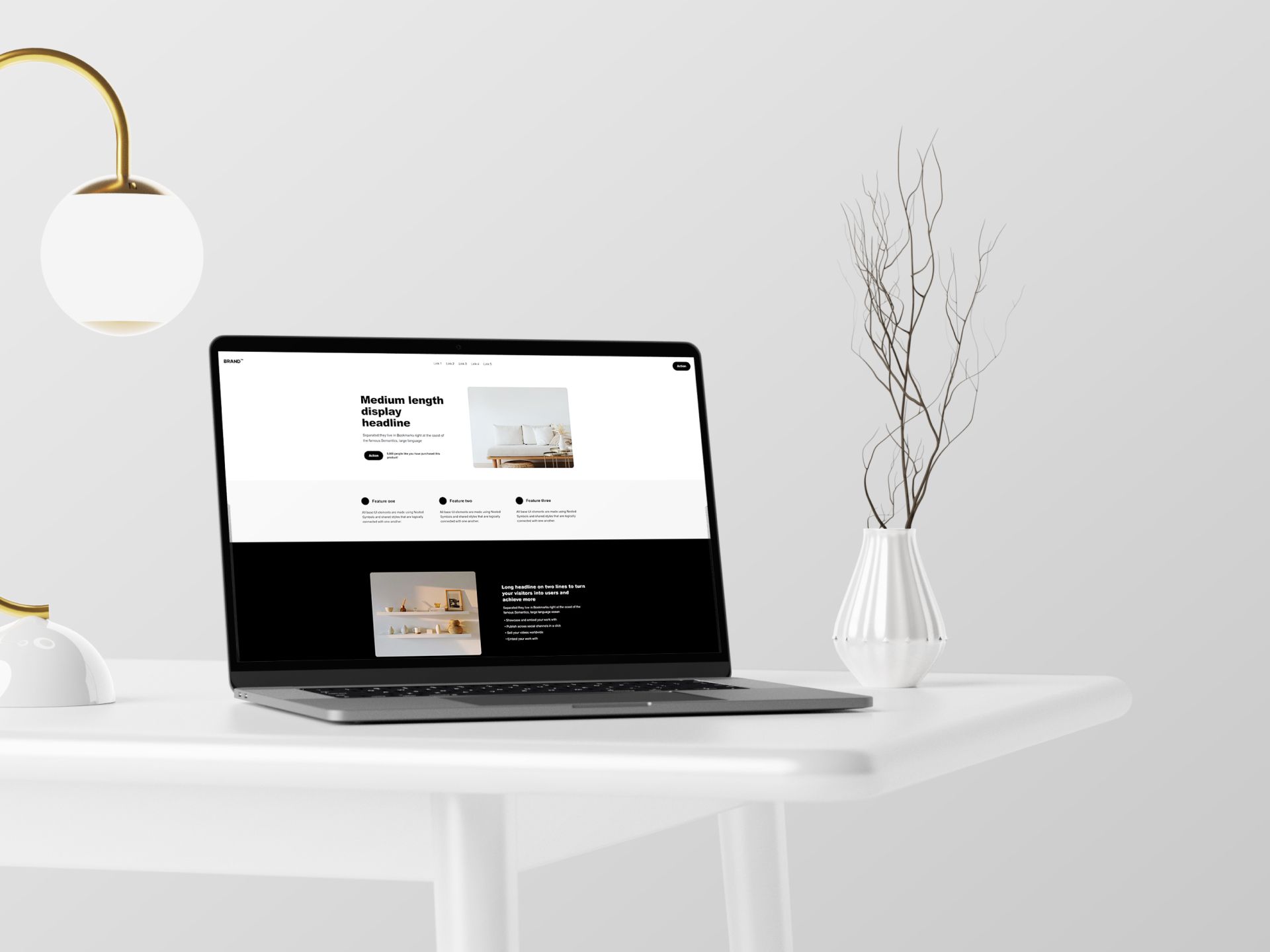 A mockup of a website on a Macbook with a desk lamp to the left and a vase to the right